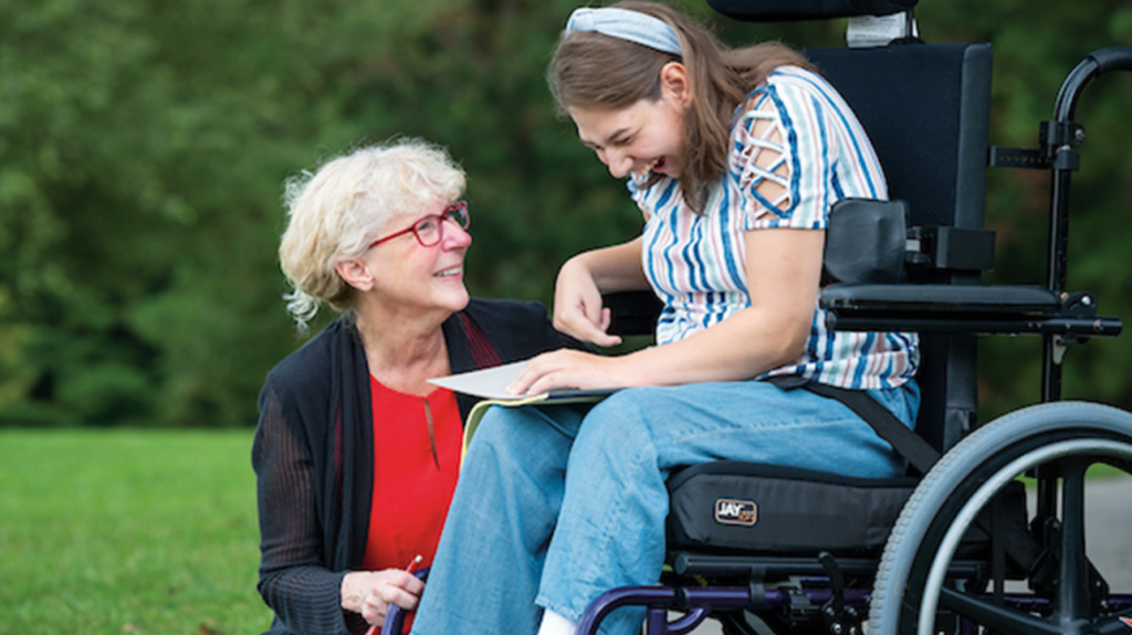 Ryndak working with student in wheelchair